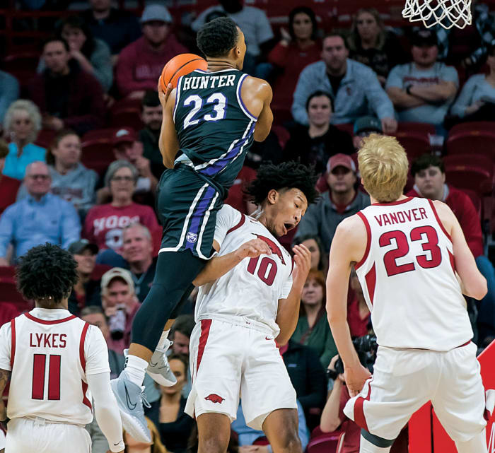 Central Arkansas Bears guard Camren Hunter (23) is called for a charge against Arkansas Razorbacks forward Jaylin Williams (10) during the second half at Bud Walton Arena. Arkansas won 97-60.